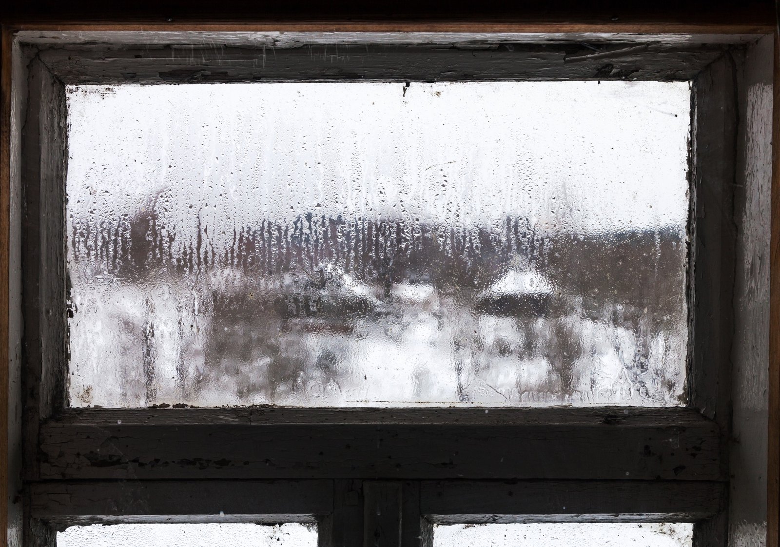 Beschlagenes Fenster im Winter mit Frost